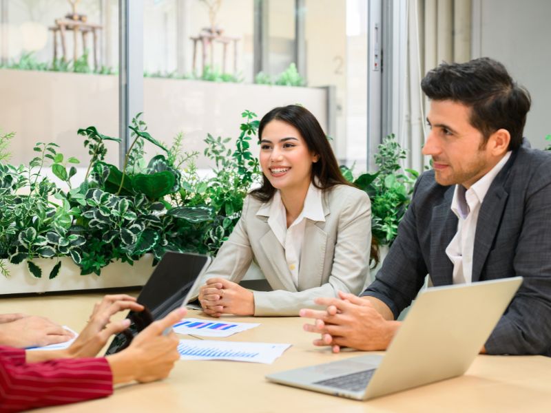 Young professionals networking and discussing job opportunities in Aruba offices.
