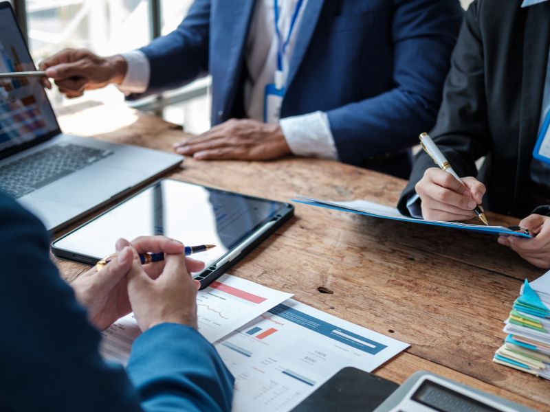 Business professionals reviewing documents related to work authorization in Aruba