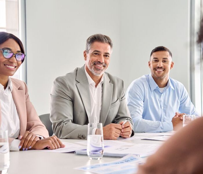 Diverse business team in a meeting room discussing HR services in Aruba