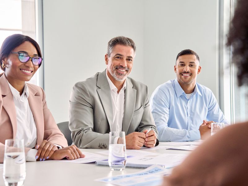Diverse business team in a meeting room discussing HR services in Aruba