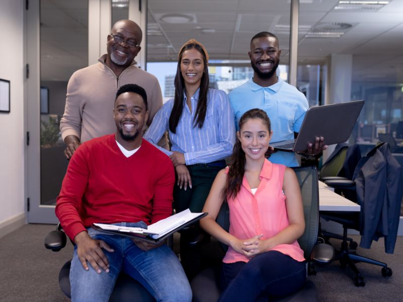Diverse professional team at a recruitment agency in Aruba smiling in a modern office