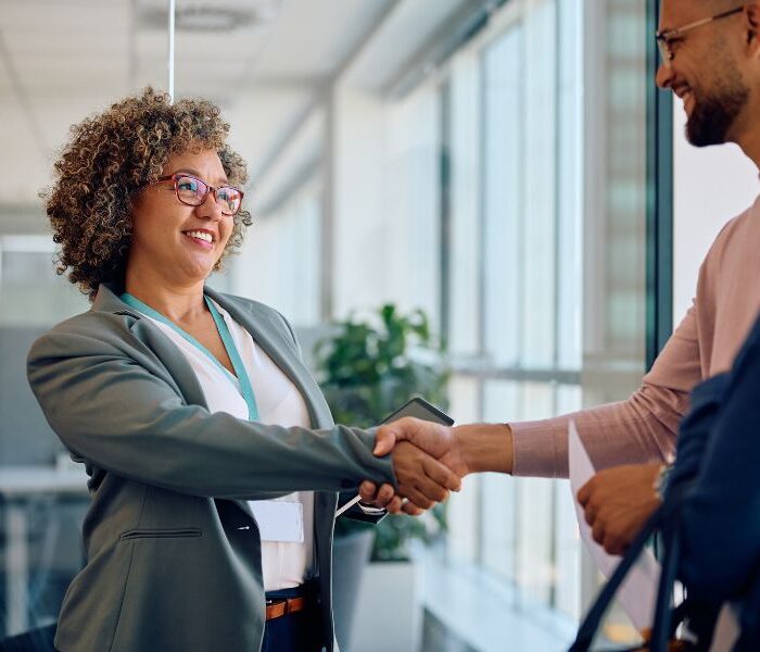 Business professional greeting candidates at a staffing agency office in Aruba