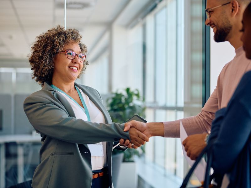Business professional greeting candidates at a staffing agency office in Aruba